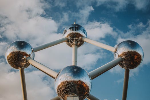 Iconic spherical structure Atomium in Brussels against a blue sky. by lil artsy