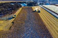 Farm Tractor Harvesting on Field