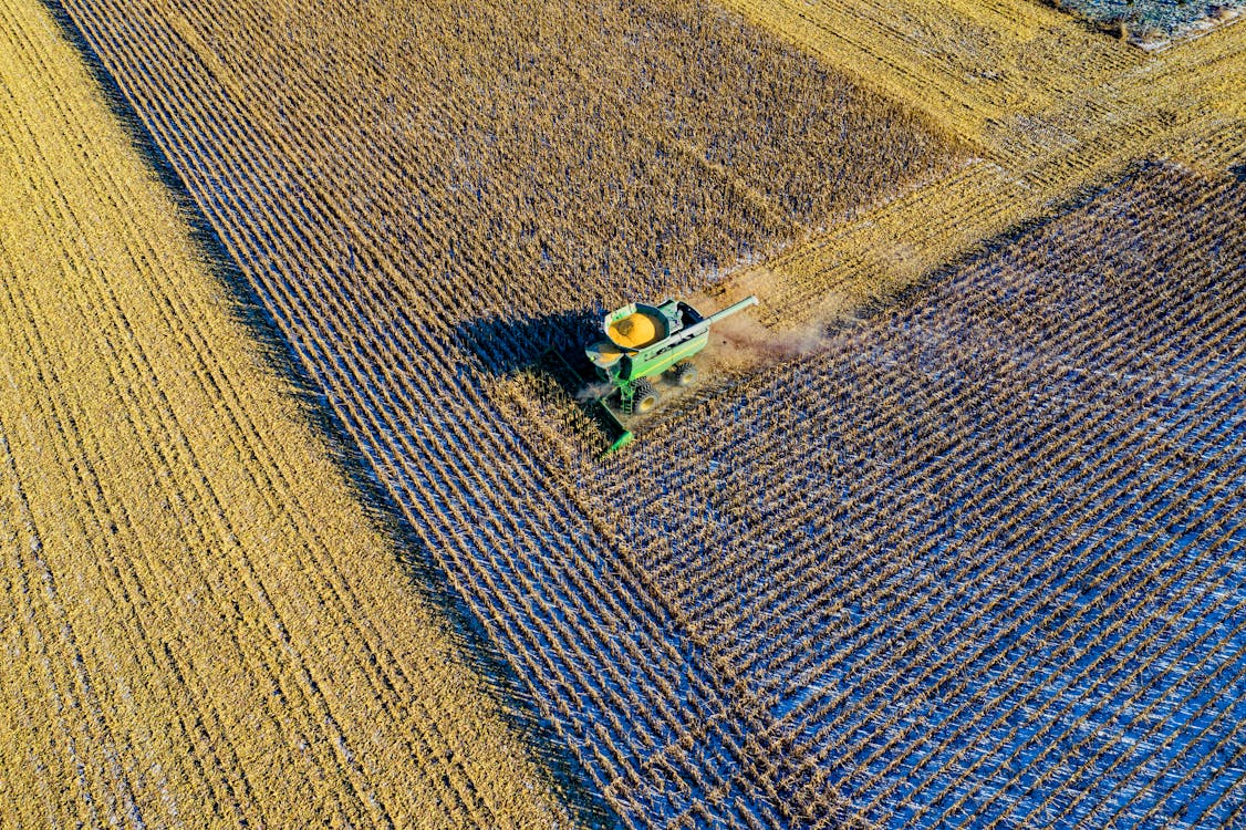 Aerial Photo Of Milling Truck On Field Harvesting Crops