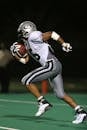 Football Player Holding Football