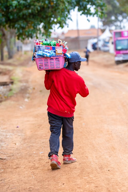 Man Carrying Basket with Merchandise