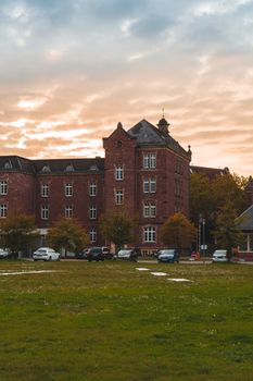 A stunning view of a historic red brick building in Karlsruhe during sunset.