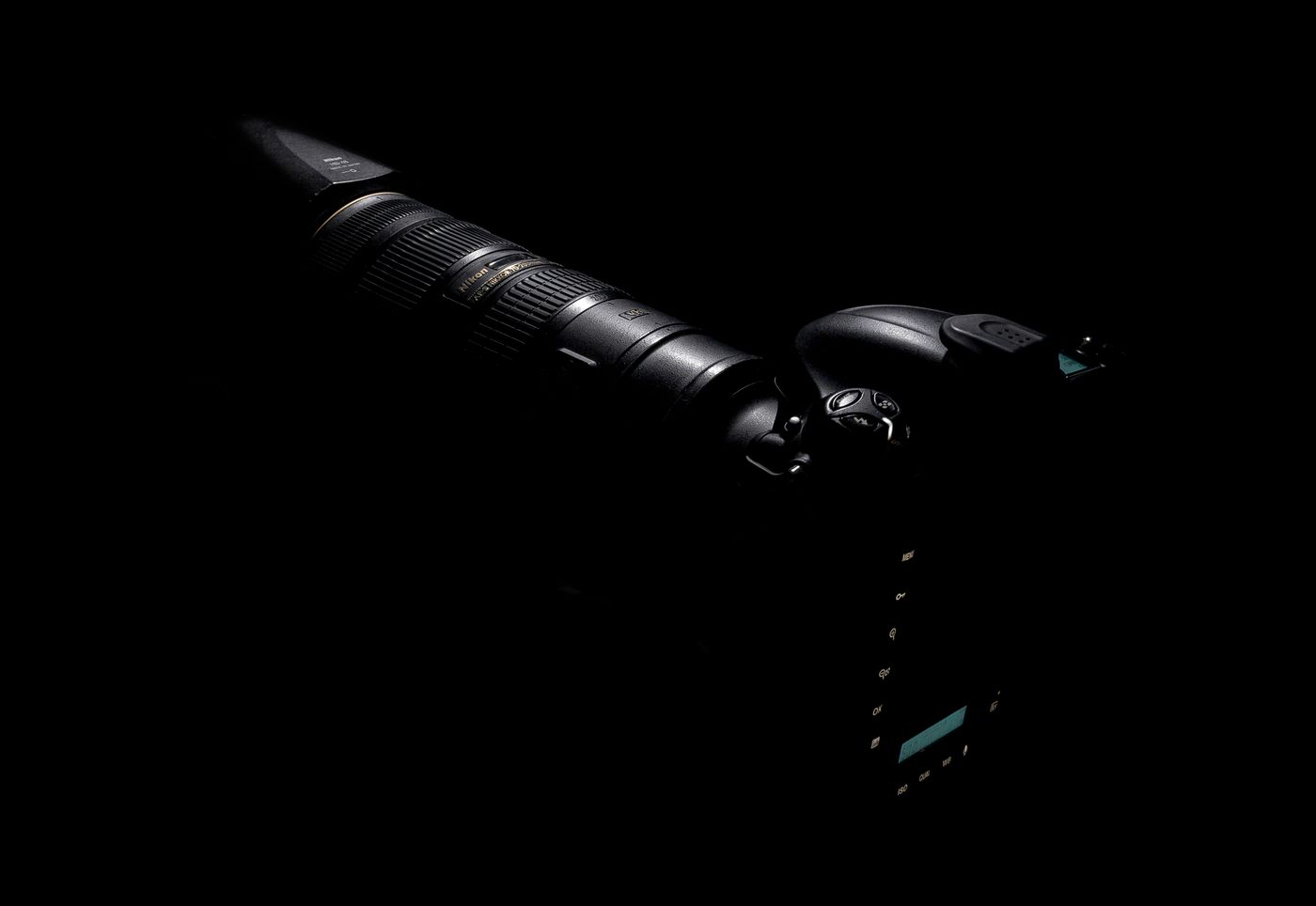 Camera and lens against a dark background