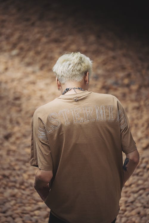 Back View of a Young Man with Dyed Platinum Hair in a Beige T-shirt