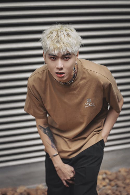 Young Man with Dyed Platinum Hair in a Beige T-shirt