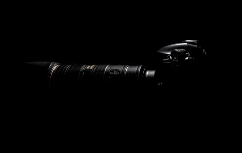 Free Artistic close-up of DSLR camera lens in dark, moody lighting. Stock Photo