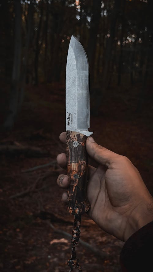 Close-up of Man Holding a Sharp Knife in a Forest