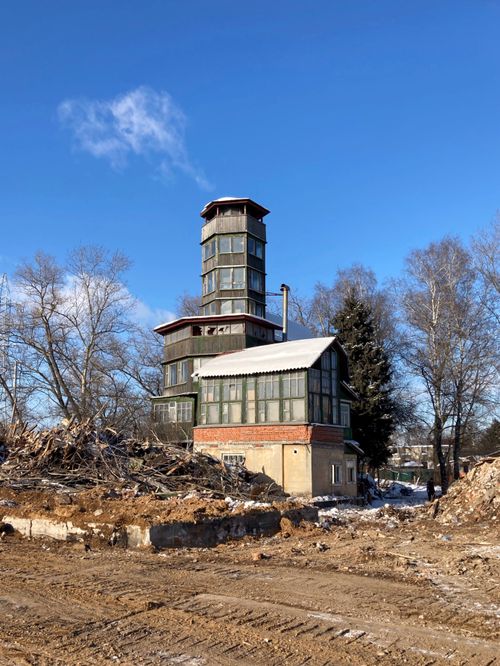 Free An old tower surrounded by debris under a clear blue sky in Russia. Stock Photo