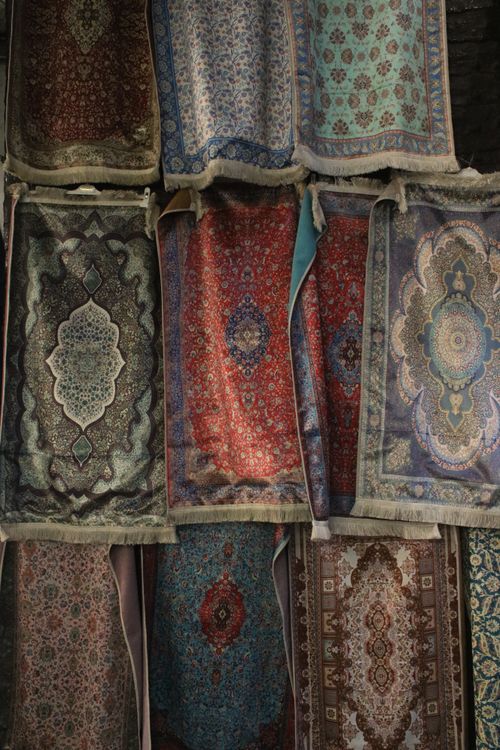 Free A variety of intricate Turkish carpets on display at a market stall. Stock Photo