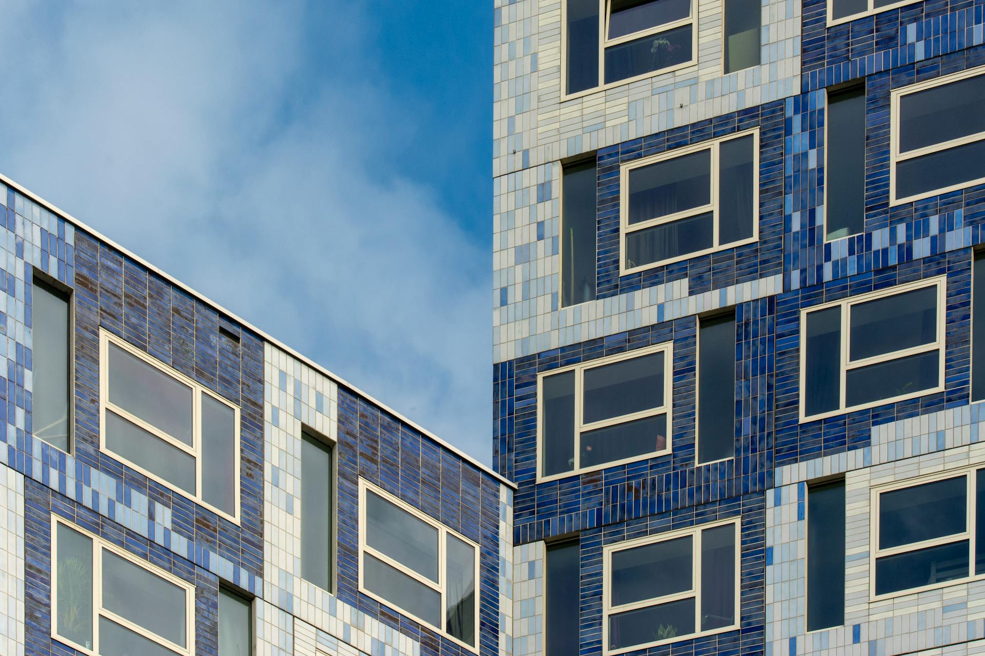 Close-up of modern student housing facade with blue tiles in Utrecht, Netherlands.