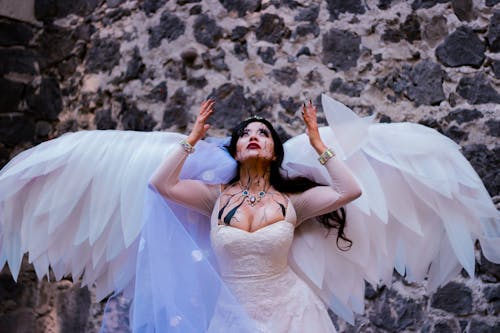 Woman in Wedding Dress with Angel Wings for Halloween