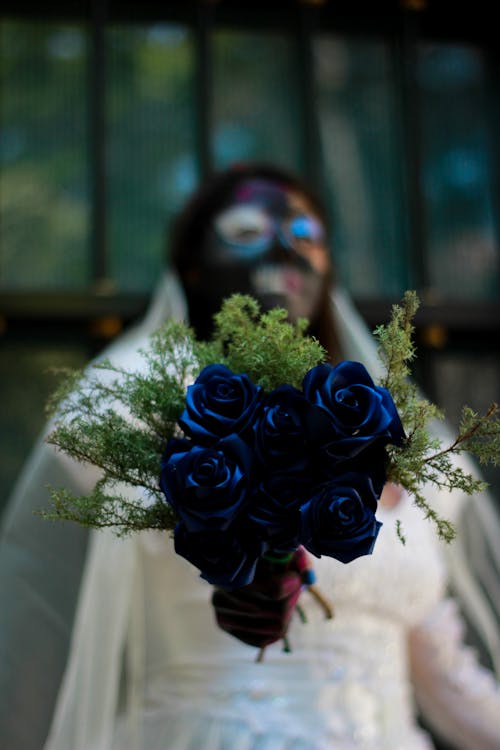 Bride Holding Blu Roses Bouquet