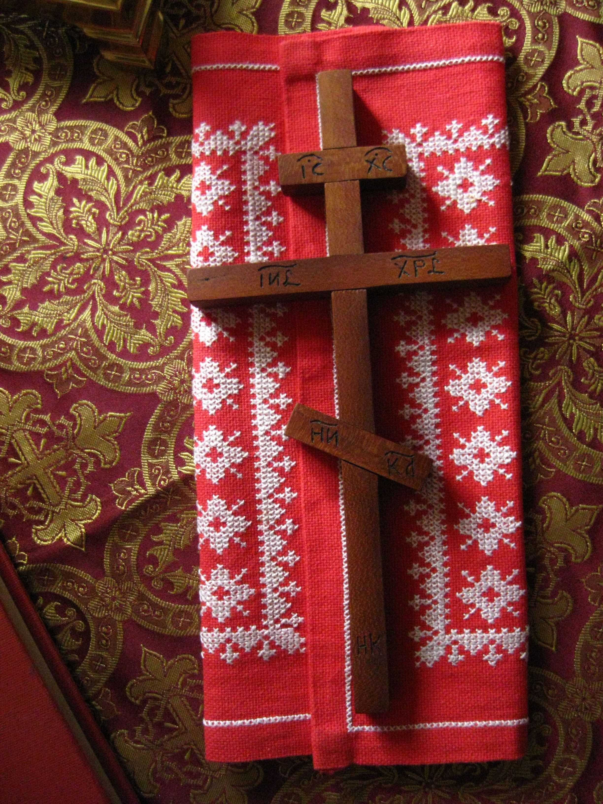 Ornate Orthodox cross on embroidered fabric, showcasing traditional religious symbolism.