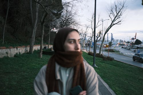 City Street with a Woman Wearing a Hijab in the Foreground