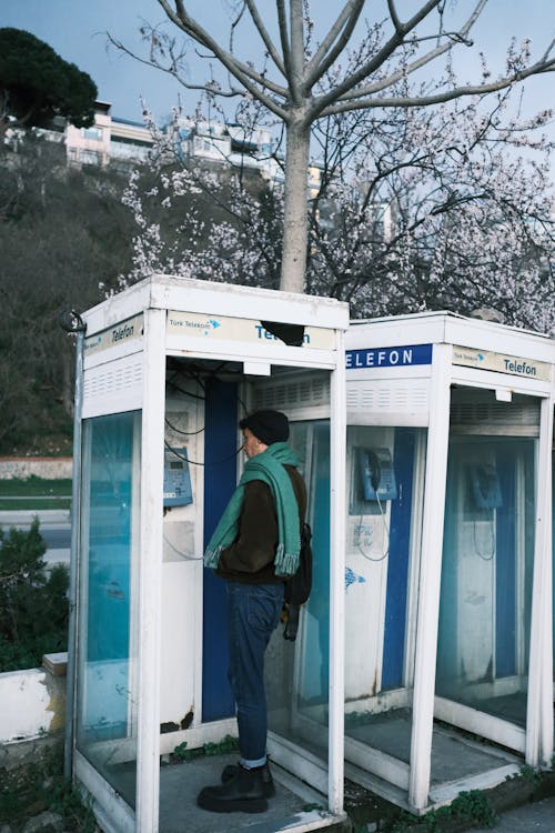 Person Standing in Phone Booths