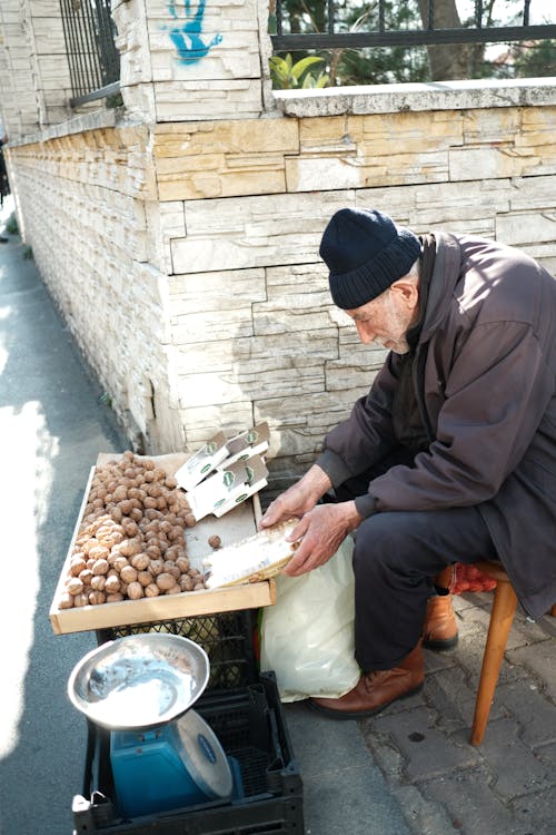 Elderly Man Selling Potatoes on the Street in City 
