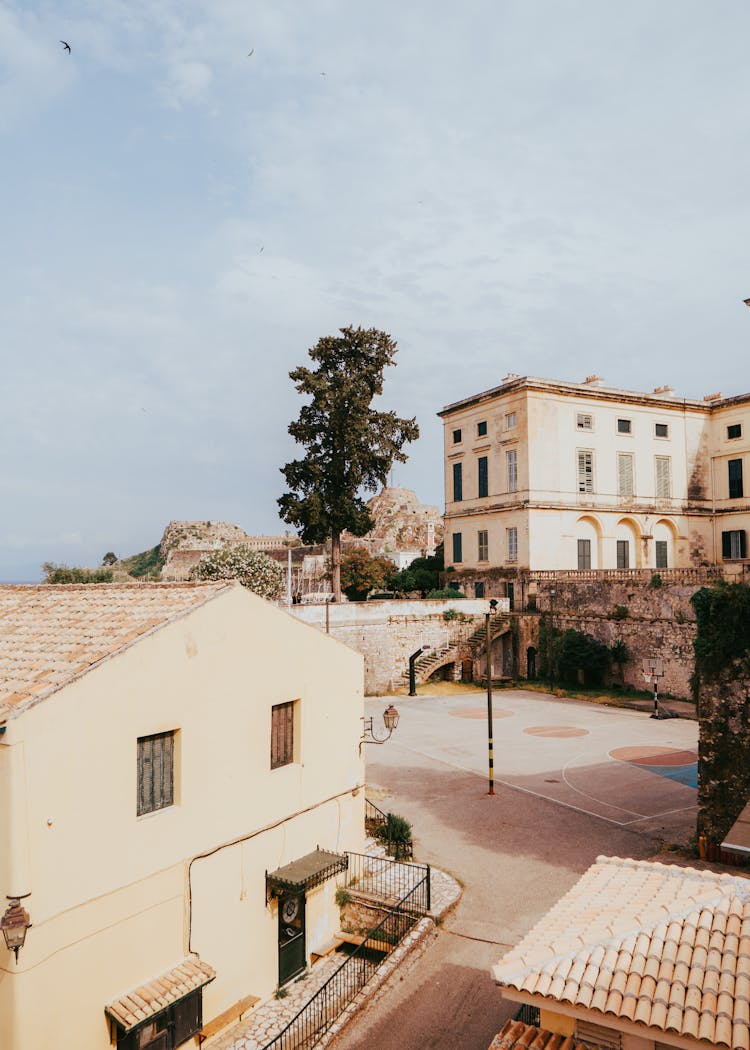 View Of Buildings And A Basketball Court In Agios Gordios, Corfu, Greece