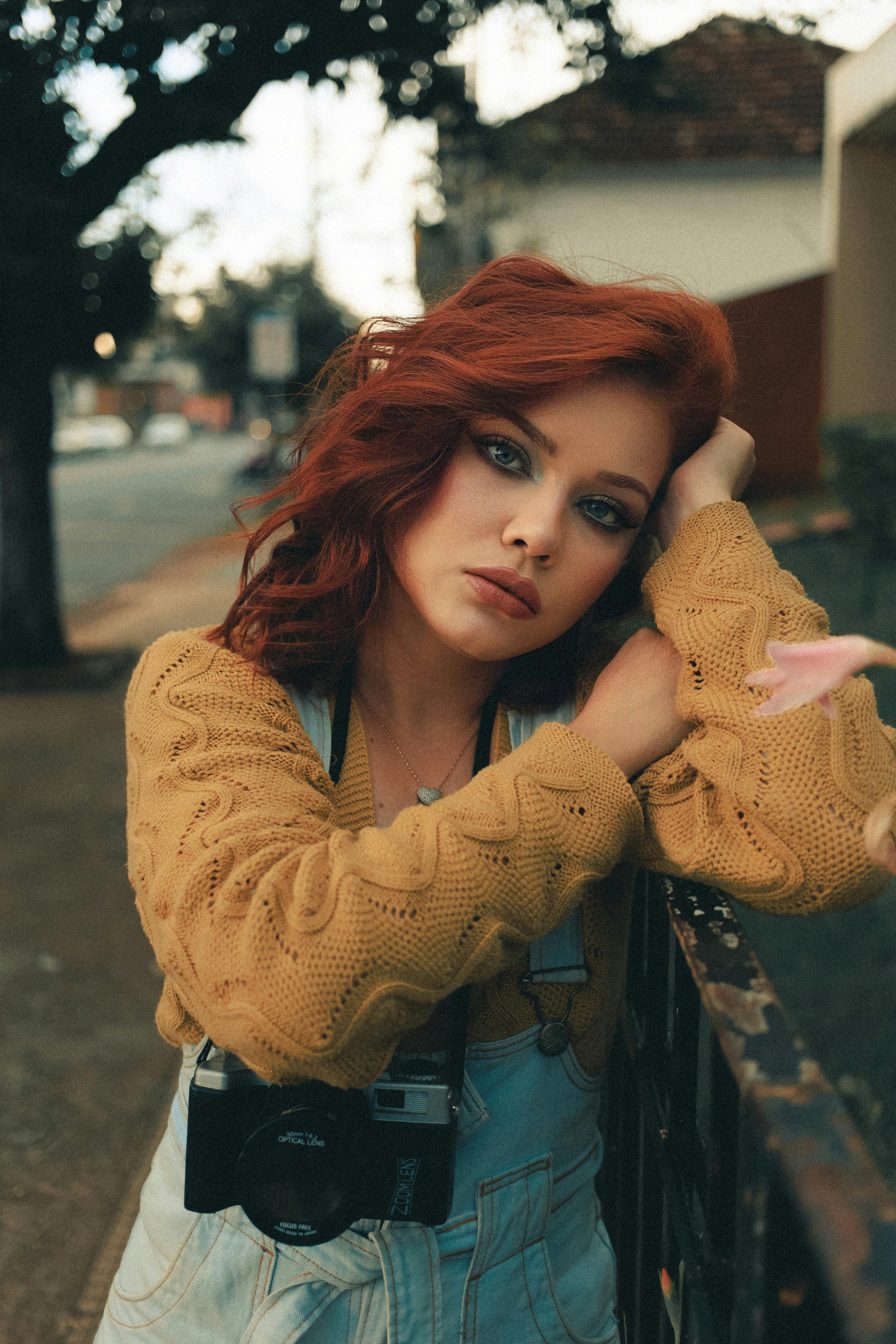 Portrait of a Pretty Redhead Leaning on a Railing · Free Stock Photo