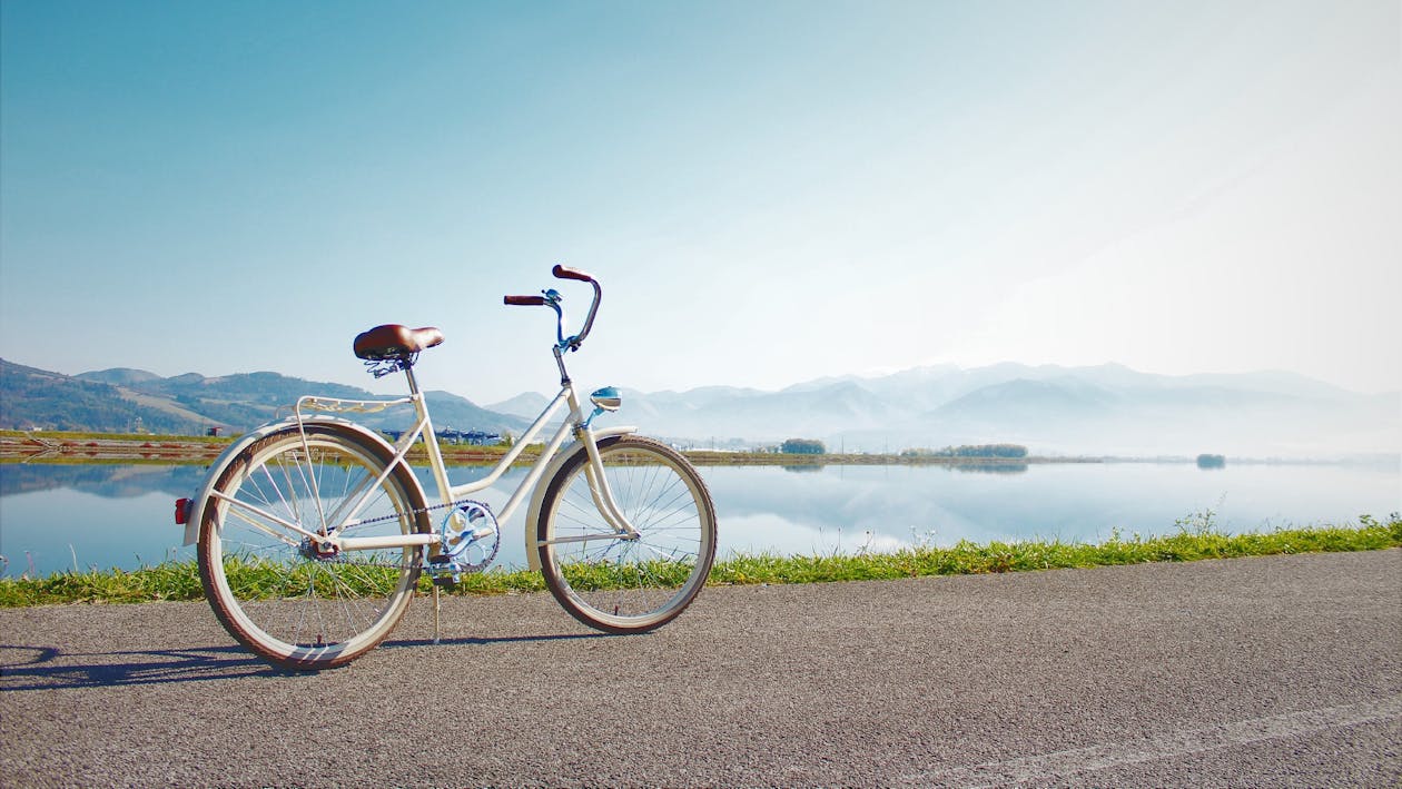 Free Gray Commuter Bike Parked on Road Beside Sea Stock Photo