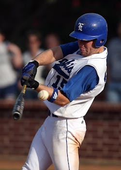 Photo by Pixabay Dynamic shot of a baseball player swinging a bat during a game, wearing a blue and white uniform.