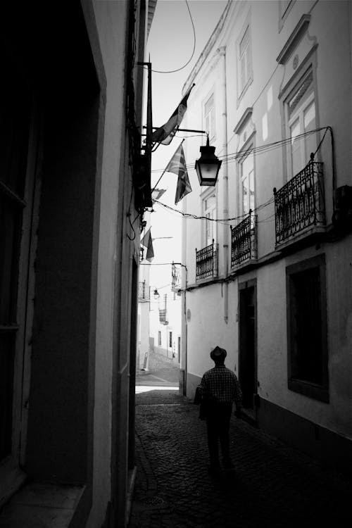 Silhouette of Person in Narrow Alley in Black and White
