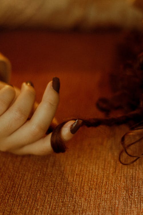 Hand of a Woman Playing with Her Hair