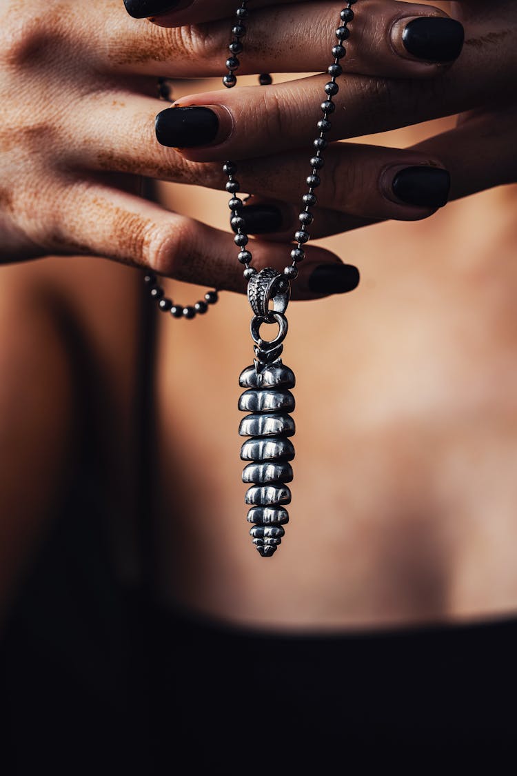 Woman Hands Holding Silver Necklace