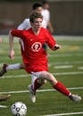 Man in Red Nike Jersey Shirt Playing Soccer