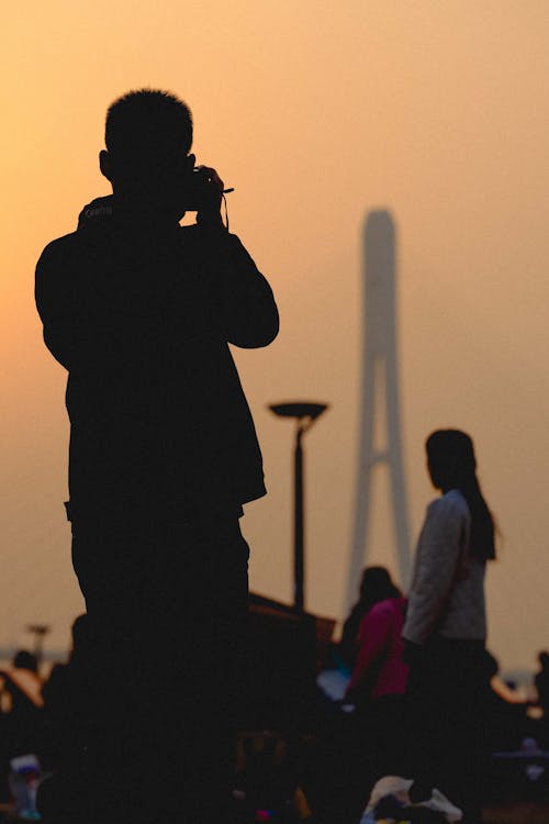 Silhouette of Man Taking Pictures