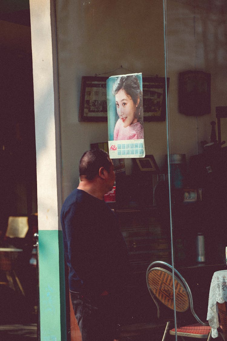 Man Looking Through Storefront