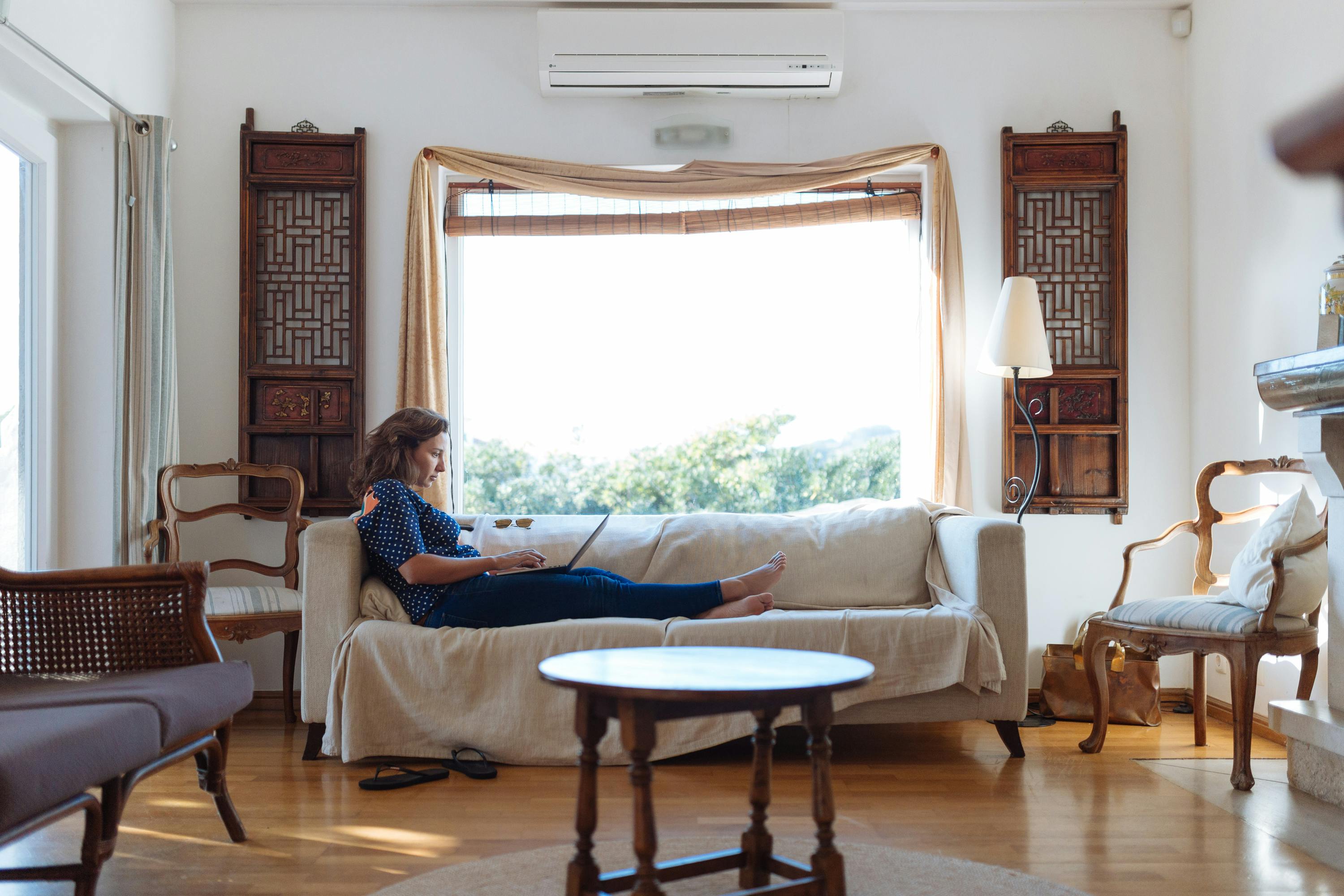 Woman Sitting on Sofa in Living Room · Free Stock Photo