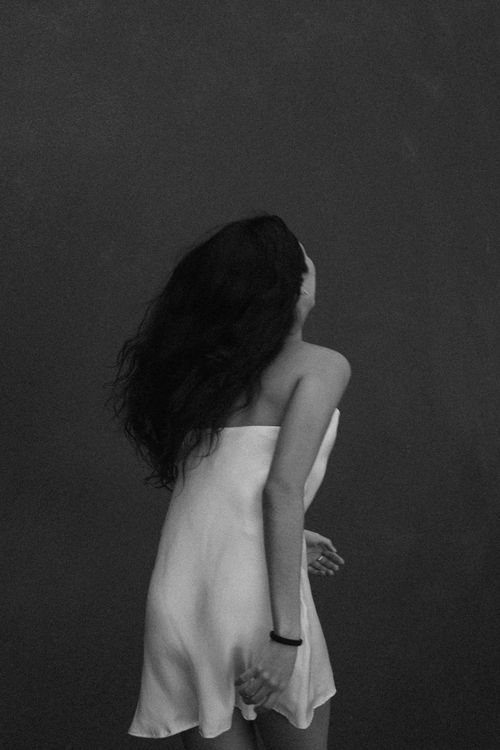 Free Black and white portrait of a woman in a flowing white dress with long hair. Stock Photo