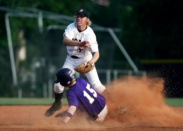 2 Man Playing Baseball On Brown Field