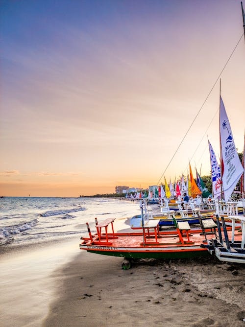 View of Boats on the Beach under a Sunset Sky 