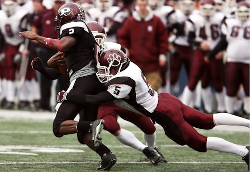 Exciting tackle during an American football game highlighting teamwork and athletic skill.