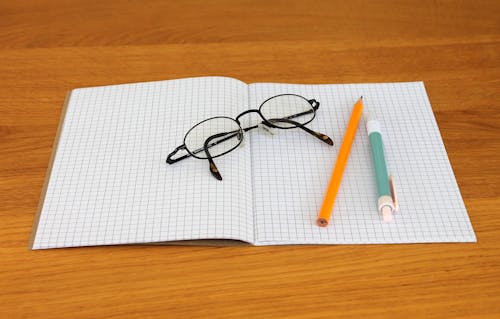 Free Black Framed Eyeglass on Graphing Paper Stock Photo