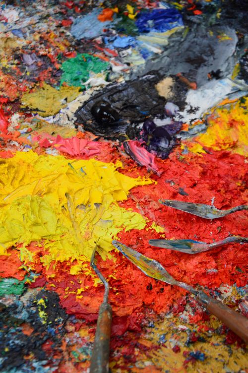 Free Colorful abstract paint texture with palette knives for artistic inspiration. Stock Photo