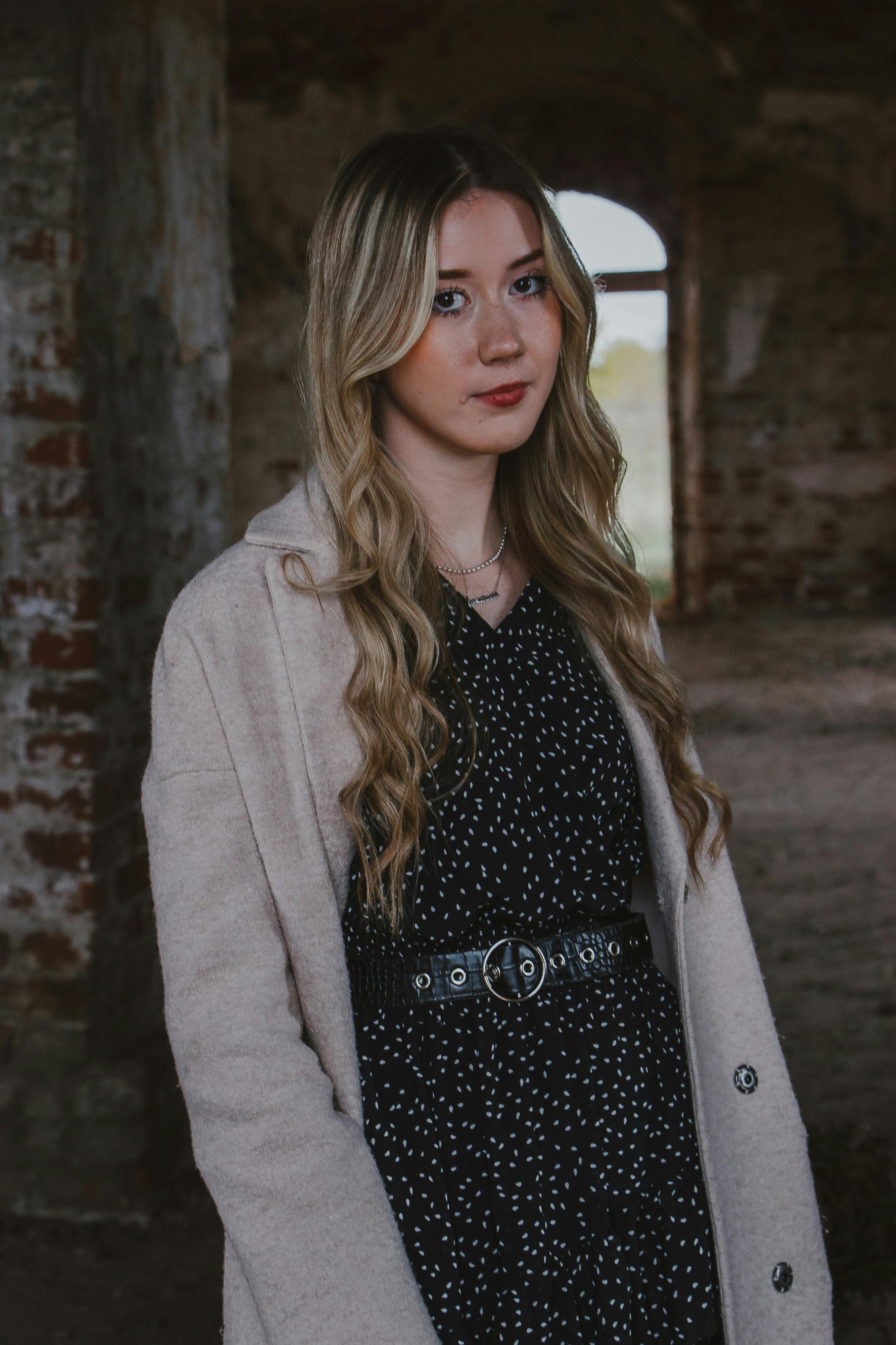 blonde posing in dress and coat