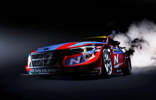 Free High-performance Hyundai race car emitting smoke on a dark track. Stock Photo