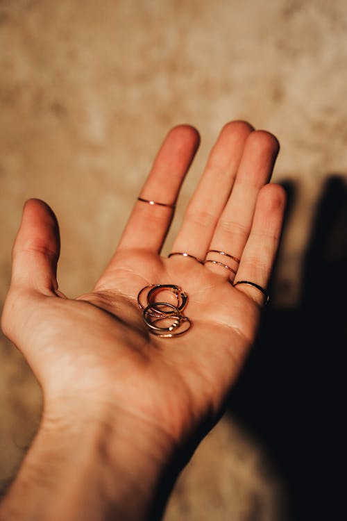 Woman Holding A Bunch of Rings in Her Hand