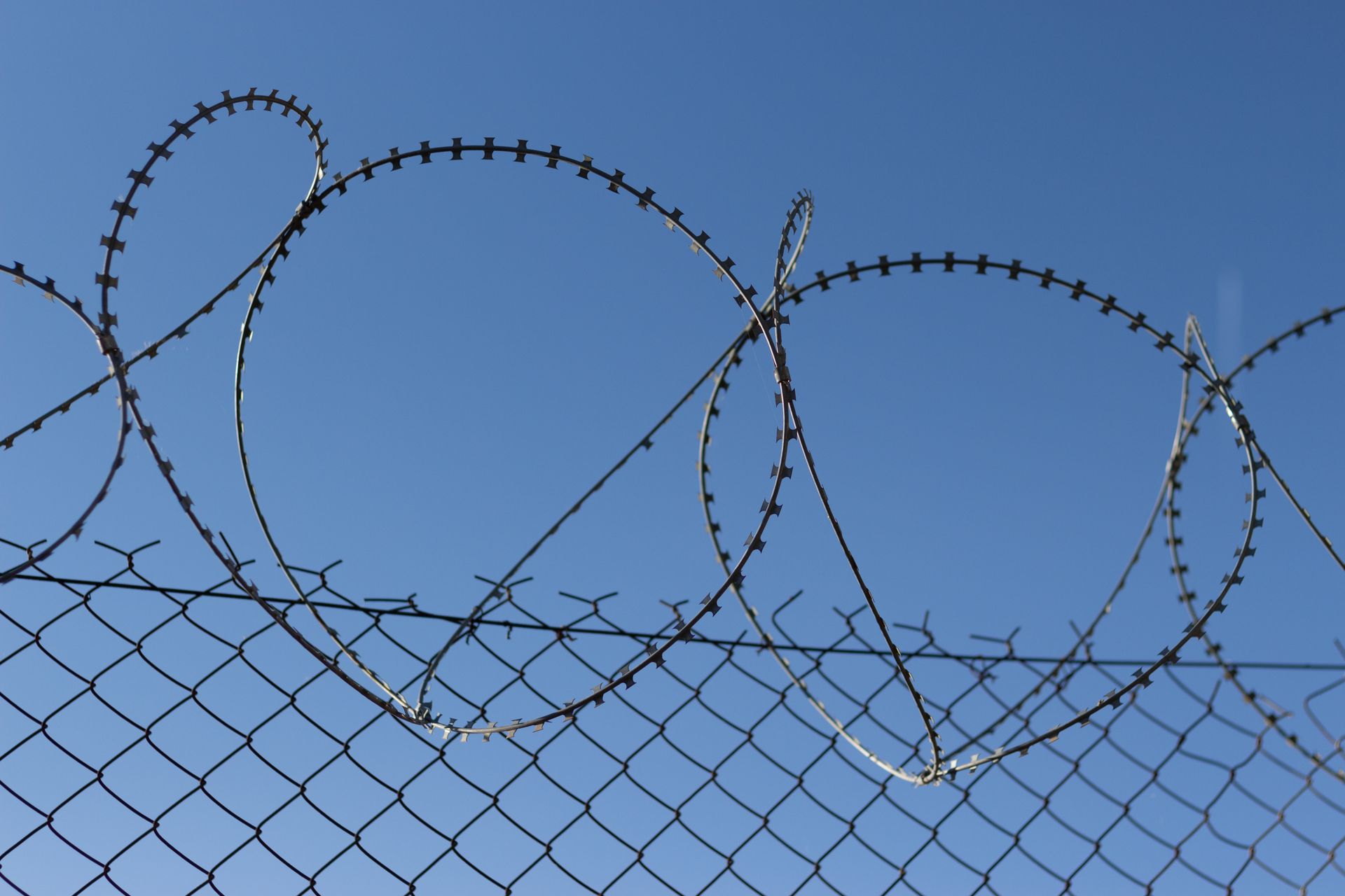 Barbed Wire on Top of a Fence