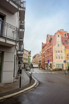 Charming street view showcasing colorful buildings in Poznań, Poland with architectural details.