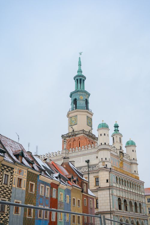 Free View of a historic town hall with colorful buildings in a snowy, urban setting. Stock Photo