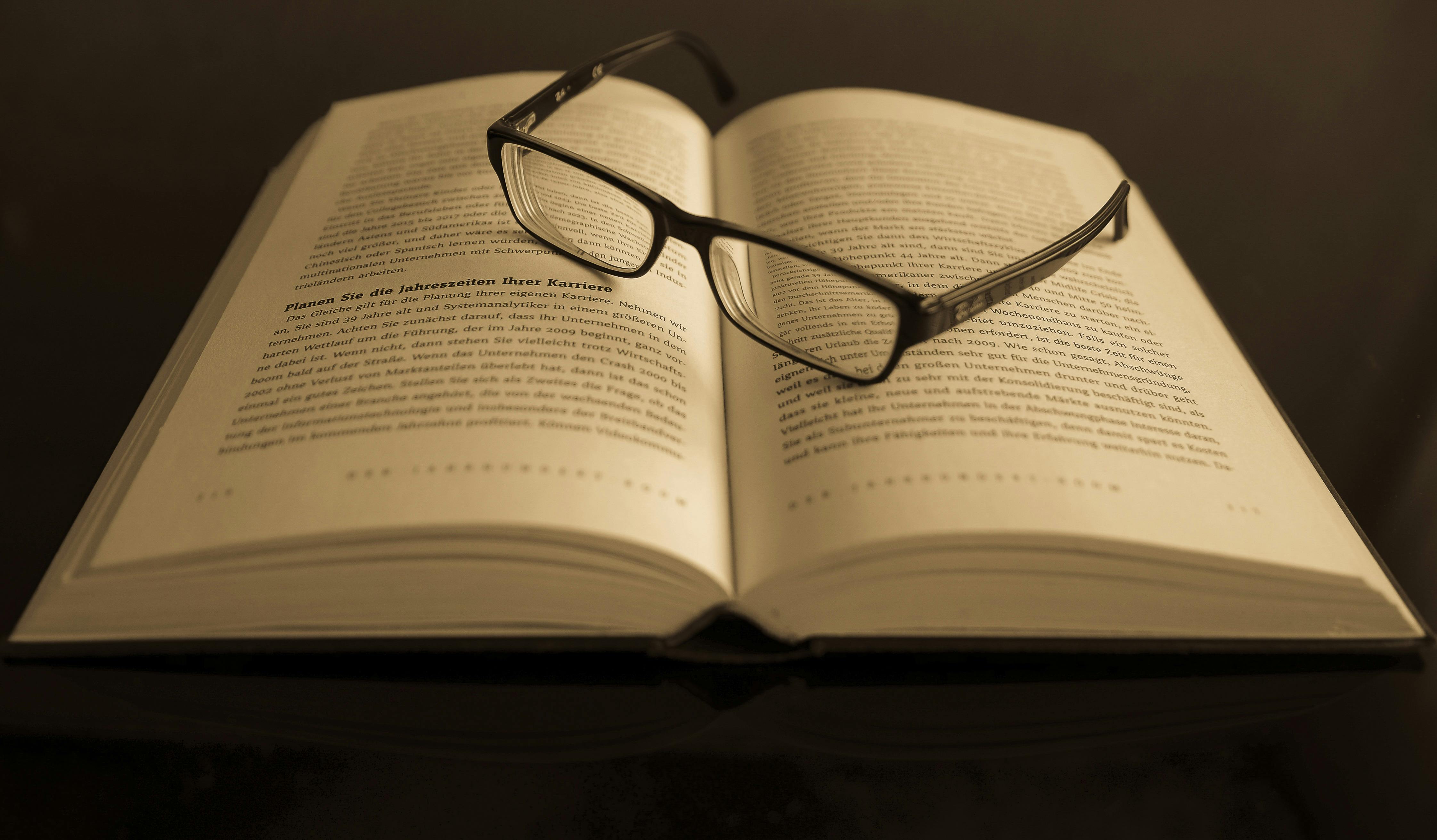 Eyeglasses With Black Frames on Book · Free Stock Photo