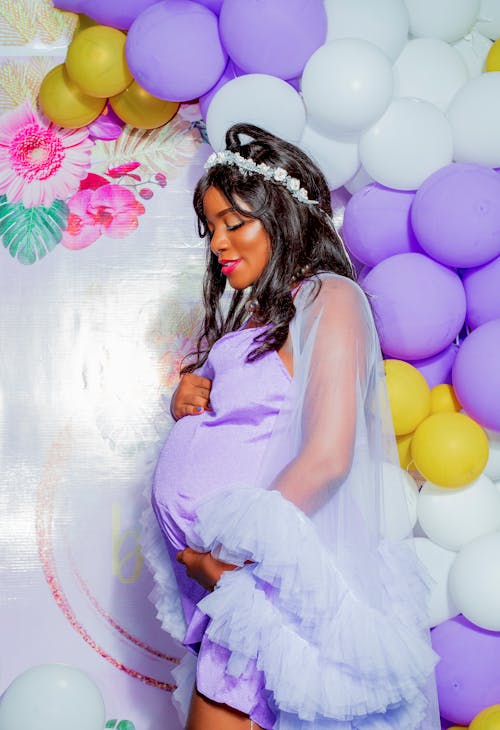 Pregnant Woman Posing in Purple Dress