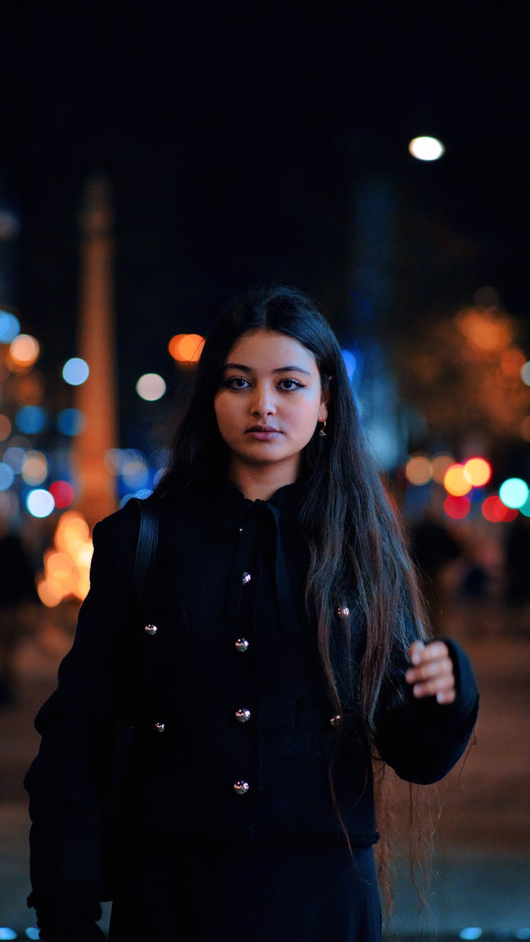 Young Brunette In Jacket In City At Night