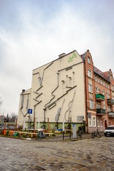 Capture of an urban building with an artistic mural facade showcasing urban creativity. - Fotografer Sidoarjo