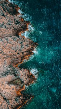 Stunning aerial view of the rocky Montenegro coastline meeting the turquoise sea.