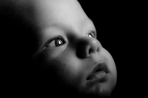 Free Black and white portrait of a baby's face in studio lighting. Stock Photo