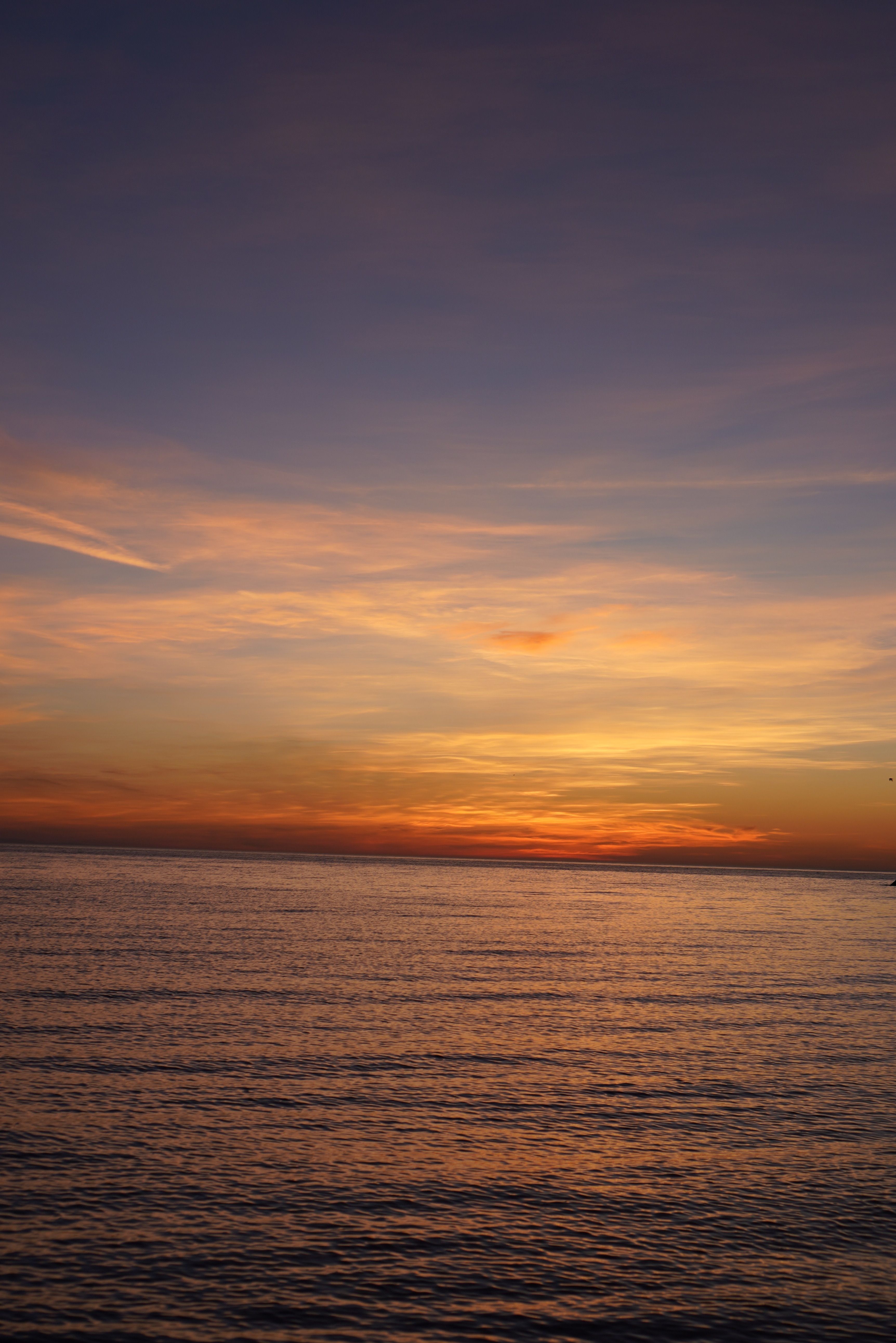 Silhouetted Boat on the Sea at Sunset · Free Stock Photo